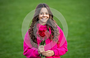 glad teenager girl with fall flowers outside. photo of teenager girl with fall flowers