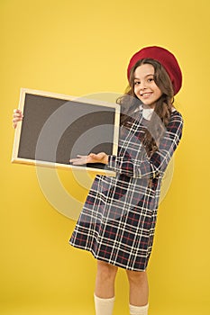 Glad to inform you. Happy child with promo board. Place for ad or announcement. Girl with smile hold blank blackboard