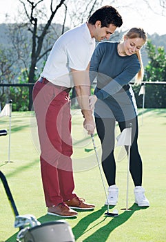 Glad trainer showing player how to hit ball