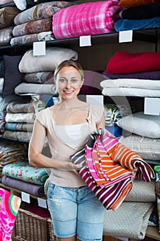 Glad woman choosing blanket