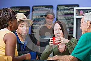 Glad Woman with Friends in Cafe