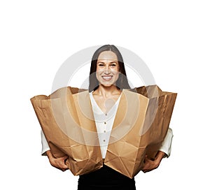 Glad woman holding paper bags over white