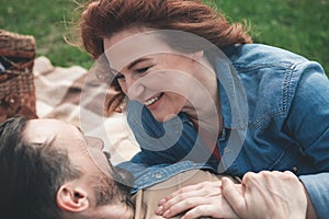 Glad woman looking into man eyes with love outdoor