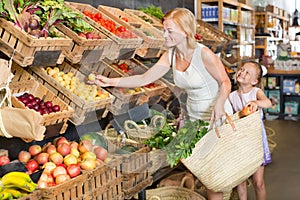 Mother with daughter shopping fruits