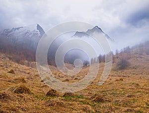 Glade with dry grass in a mountain valley