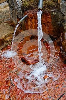 Glade of Narzans. Natural source of mineral sparkling water with a rusty bottom