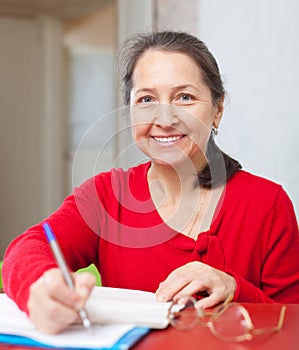 Gladful woman fills in documents