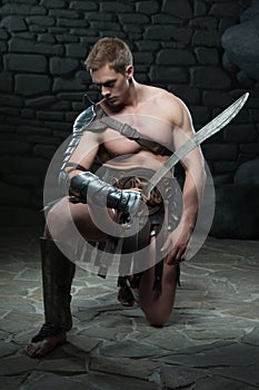 Gladiator with sword kneeling