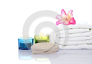 Gladiola, towel,candles and river stones