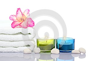 Gladiola,white towel,candles and white river stones