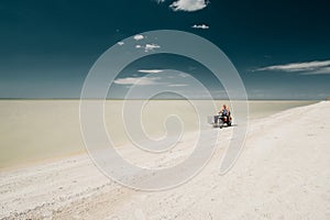 Glafirovka, Krasnodar Territory, Russia. July 29, 2020 A young man rides an old motorcycle with a sidecar on a white