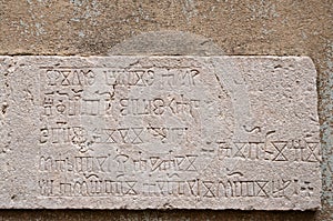 Glagolitic script on stone background