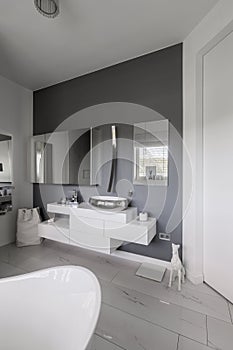 Glamor bathroom interior with trendy grey design with white furniture