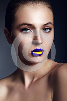 Glamor closeup portrait of beautiful stylish young woman model with bright makeup, with creative colorful bright blue yellow