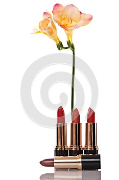 Glamor red shiny lipstick and yellow flower