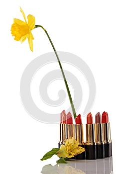 Glamor red shiny lipstick and yellow flower