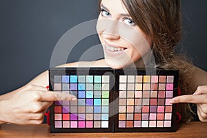 Glamor woman pointing on colorful palette for fashion makeup