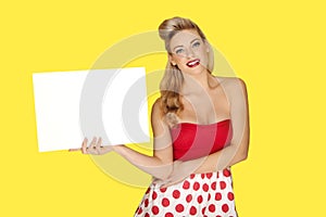 Glamorous blonde woman with a blank sign