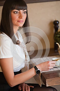 Glamorous brunette in a cafe