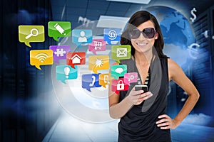 Glamorous brunette using smartphone with app icons