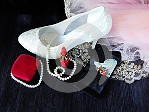 Glamorous composition made of white heels, red lipstick and photo of it taken with smartphone