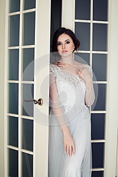 Glamorous fashion model woman with makeup and bridal hair at home