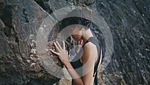 Glamorous girl posing rocks at cloudy shore closeup. Stylish fashion model touch