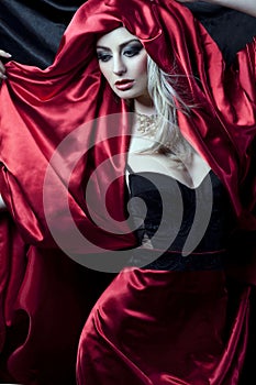 Glamorous girl in red robe