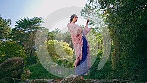 Glamorous girl standing forest lake in original clothing. Fantasy model posing
