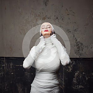 Glamorous mummy. Portrait of a young beautiful woman in bandages all over her body.