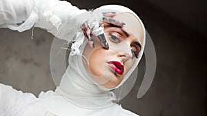 Glamorous mummy. Portrait of a young beautiful woman in bandages all over her body.