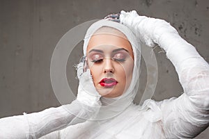 Glamorous mummy. Portrait of a young beautiful woman in bandages all over her body.