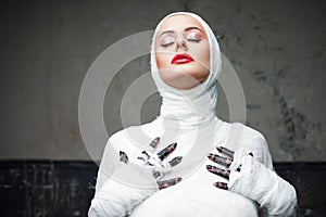 Glamorous mummy. Portrait of a young beautiful woman in bandages all over her body