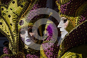 Glamorous and romantic couple with costume and venetian mask during venice carnival