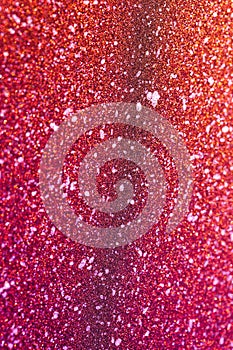 Glamorous shimmering texture. Bright pink background with graining and beautiful glitter close-up