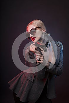 Glamorous woman in chocker and glasses with red studio light