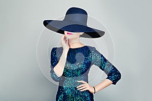 Glamorous Woman in Glitter Fashionable Dress and wide broad brim hat