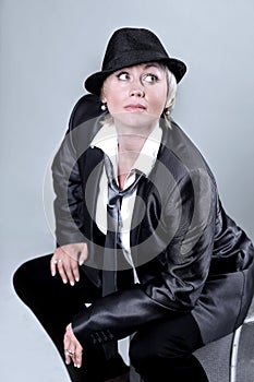 Glamorous woman in a pantsuit .isolated on gray background.