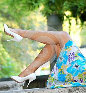 Glamorous woman with perfect legs and heels relaxi