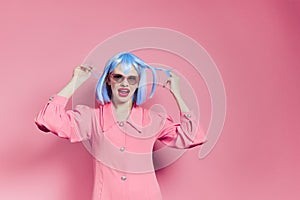 glamorous woman in sunglasses wears a blue wig makeup isolated background