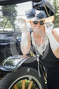 Glamorous Woman in Twenties Attire Near Antique Automobile
