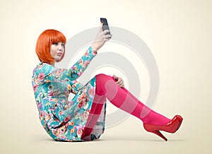 Glamorous young girl sitting with a smart phone