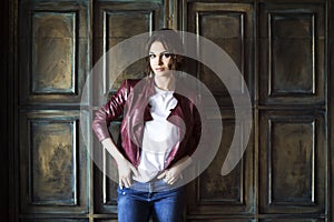 Glamorous young woman in red leather jacket