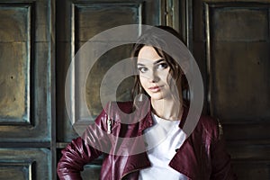 Glamorous young woman in red leather jacket