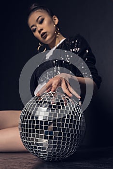 glamour asian girl posing with disco ball