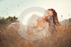 Glamour attractive girl in grass, sunset scene