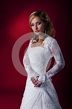 Glamour fiancee in white wedding dress.