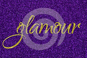 Glamour lettering word gold on ultra violet glitter texture. Shiny sparkle background