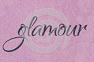 Glamour lettering word gray midnight blue black on light pink ballet slipper glitter texture. Shiny sparkle background