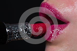 Glamour lipstick and sexy female lips of girl or woman. Wet lips and lipstick with water drops, passion, pink lips and